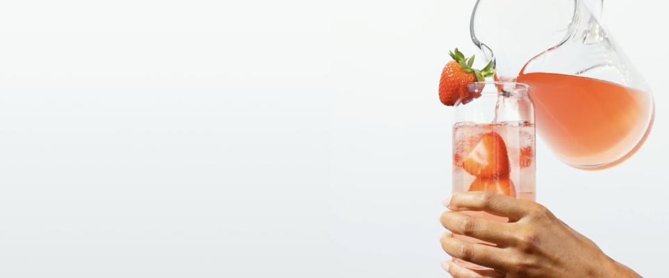 pitcher pouring water with strawberries