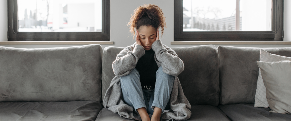 girl holding head with headache